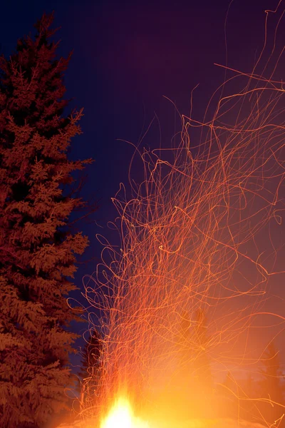 Forest fire danger hot spark trails from campfire — Stock Photo, Image