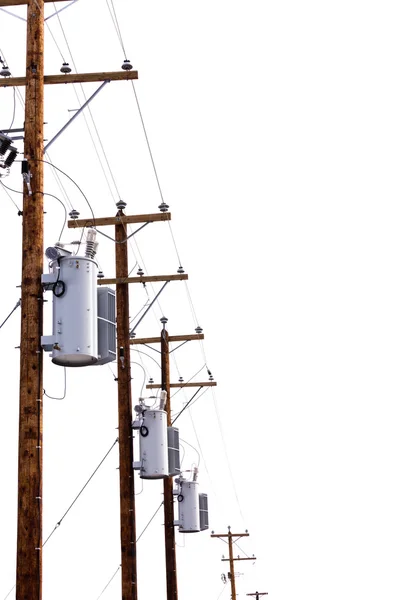 Reihe von Strommasttransformatoren isoliert auf weiß — Stockfoto
