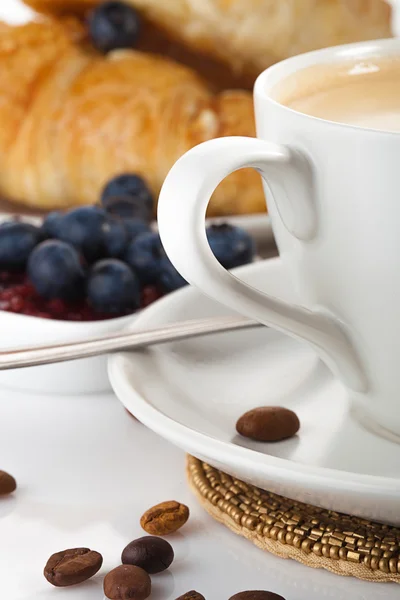 Kaffe med croissanter och blåbär på vit bakgrund — Stockfoto