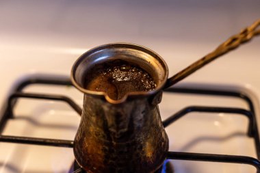coffee in a jezve on a gas stove