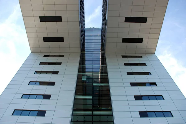 Original building with glass and steel cladding. It has an unusual shape and is located in the city of Cologne, Germany.
