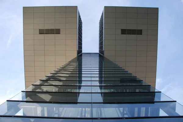 Original building with glass and steel cladding. It has an unusual shape and is located in the city of Cologne, Germany.
