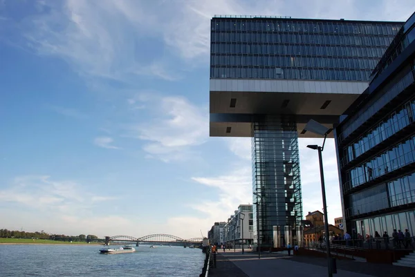 Original building with glass and steel cladding. It has an unusual shape and is located in the city of Cologne, Germany.