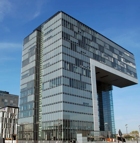 Original building with glass and steel cladding. It has an unusual shape and is located in the city of Cologne, Germany.
