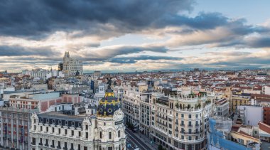 MADRID - 5 Ekim 2021: Bulutlu bir öğleden sonra Gran Via ve Madrid gökyüzü manzaralı Metropolis binası ön planda tanınacak..