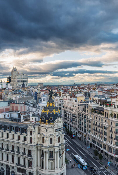 MADRID - OCTOBER 5, 2021: Aerial view of Gran Via and Madrid skyline on a cloudy afternoon, with the Metropolis building to be recognized in the foreground.