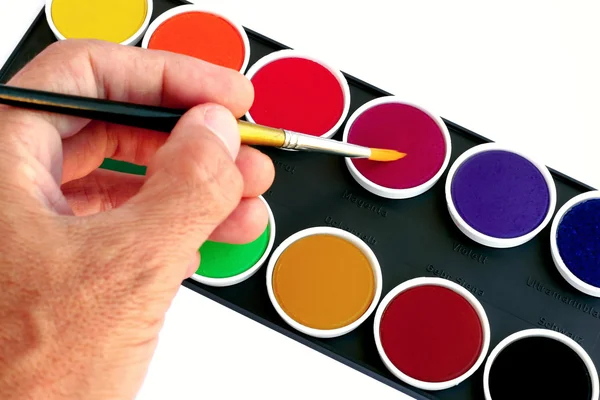 Hand with a watercolor brush — Stock Photo, Image