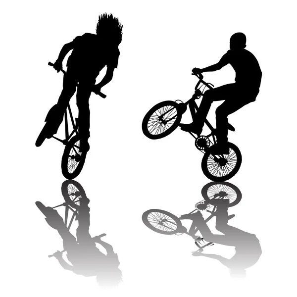 Silhouettes of bikers doing tricks — Stock Photo, Image