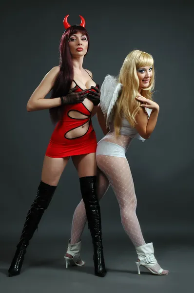 Two girls in carnival suit angel and daemon — Stock Photo, Image
