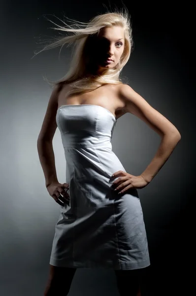 Blond girl in white dress Stock Image