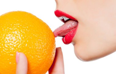 Fragment of female face with orange, close up