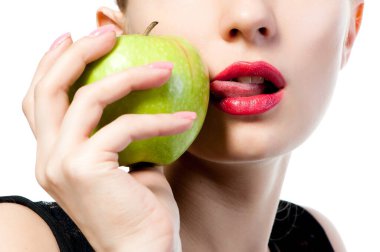 Fgagment female face with apple, close-up