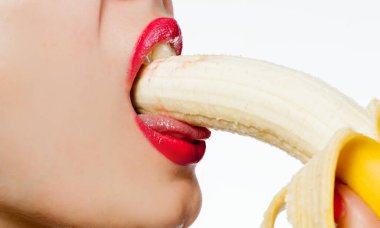 Fgagment female face with a banana close up