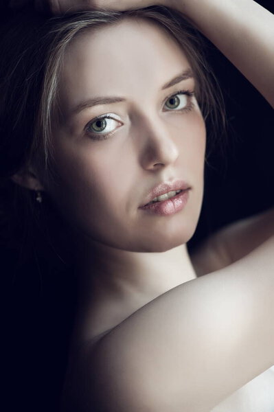 Portrait of beautiful sexy girl on a black background