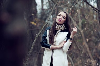 Sonbaharda ormanda poz veren uzun saçlı güzel seksi kız.