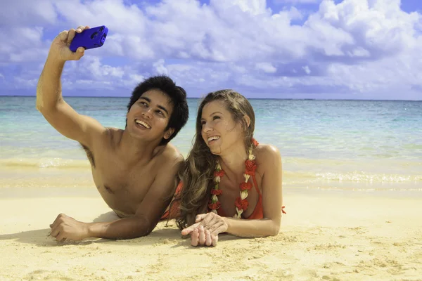 Couple with their cell phone,taking a picture — Stock Photo, Image