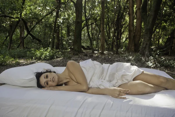Girl in bed in the woods — Stock Photo, Image