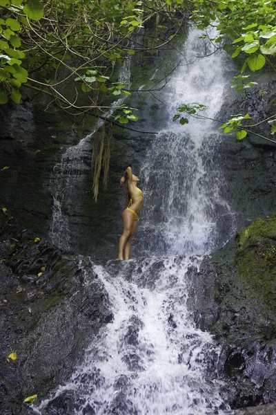 Girl in a tropical waterfall — Stock Photo, Image