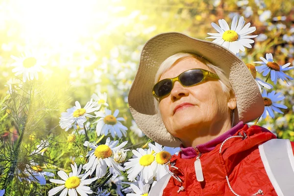 The woman on a background of flowers — Stock Photo, Image