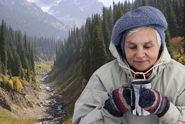 Woman drinking hot tea outdoors Stock Image