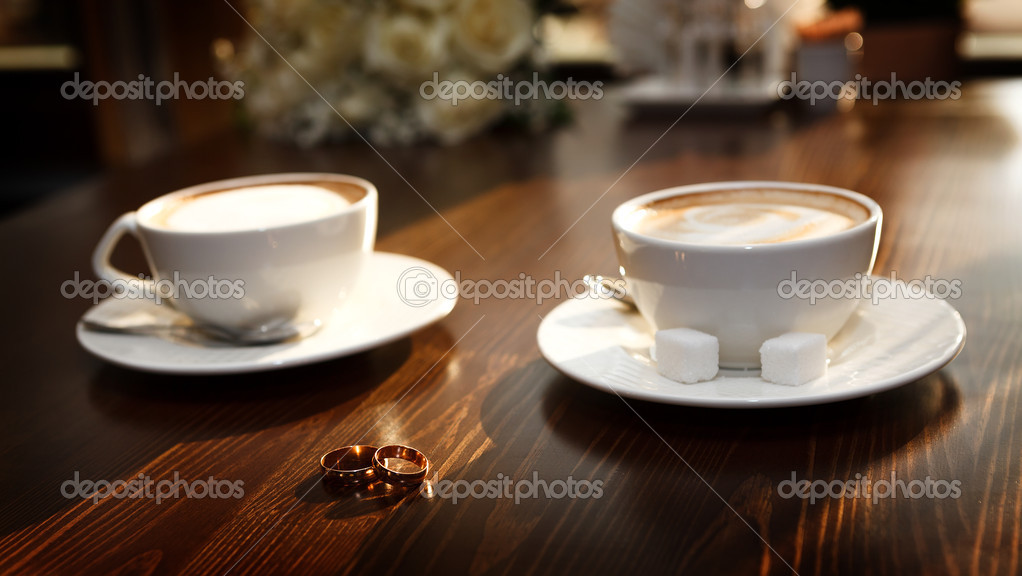 Two Cups Of Coffee On The Table With Wedding Rings Stock Photo Two Cups Of Coffee On The Table With Wedding Rings Stock Photo