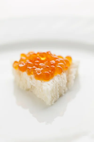 Little sendwich with Caviar on big plate — Stock Photo, Image