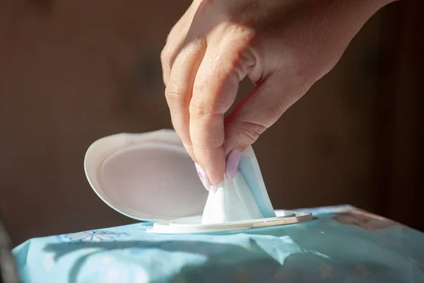 Hand picked a wet wipes in package box, Wet wipes in a woman's hand