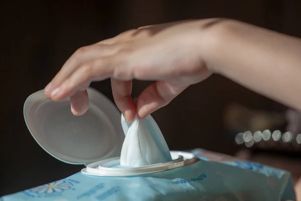 Hand picked a wet wipes from package box, Wet wipes in a children's hand