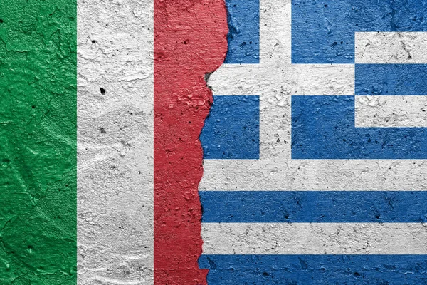 Italy and Greece - Cracked concrete wall painted with a Italian flag on the left and a Greek flag on the right