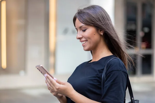 Belle Femme Souriante Chemise Noire Textant Sur Smartphone Dans Rue — Photo