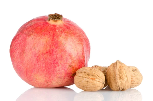 Ripe pomegranate fruit and nuts — Stock Photo, Image