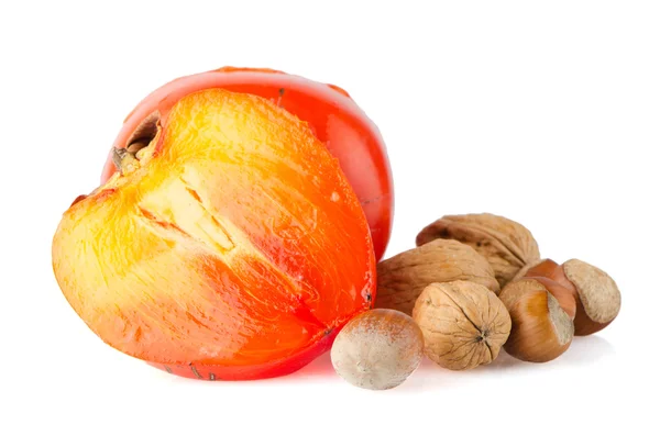 Ripe persimmons and nuts — Stock Photo, Image