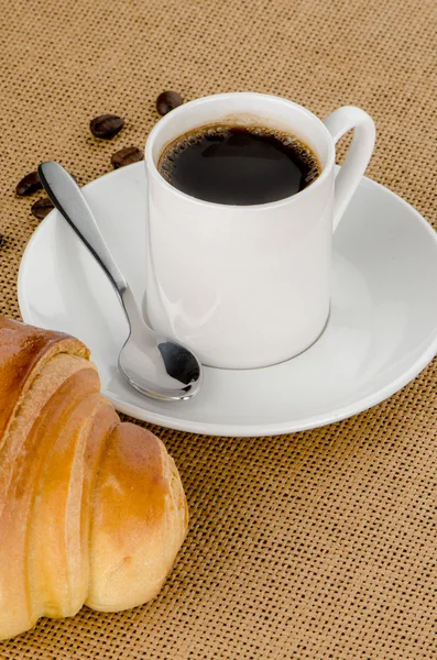 Cup of black coffee and croissant — Stock Photo, Image