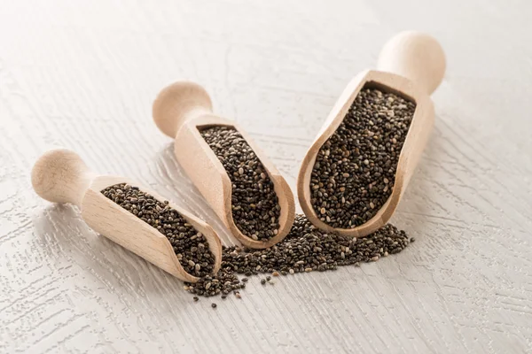 Chia seeds in wooden scoops — Stock Photo, Image