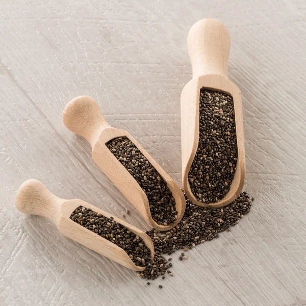 Chia seeds in wooden scoops — Stock Photo, Image