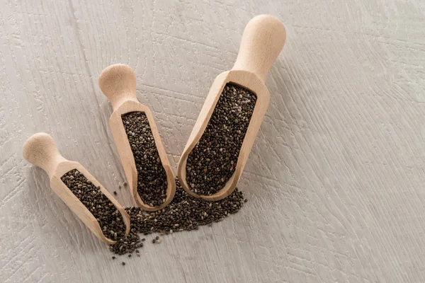 Chia seeds in wooden scoops — Stock Photo, Image