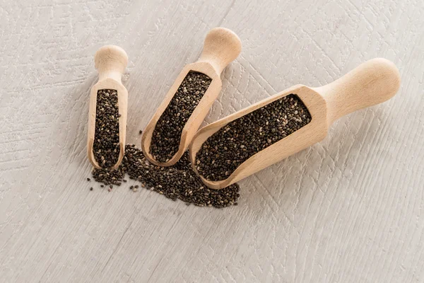 Chia seeds in wooden scoops — Stock Photo, Image