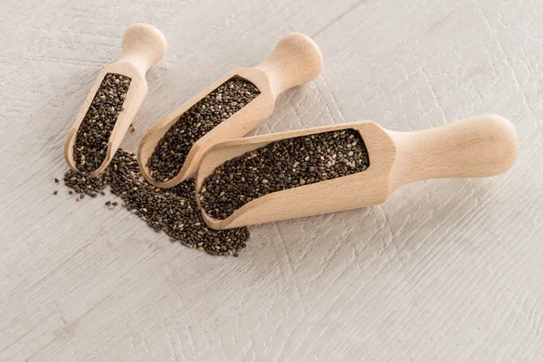 Chia seeds in wooden scoops — Stock Photo, Image