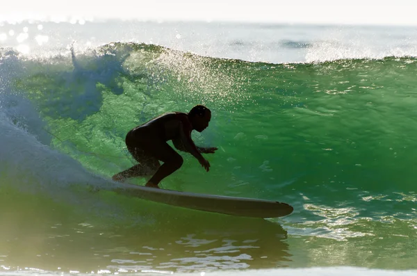 Long boarder surfing the waves at sunset — Stok Foto