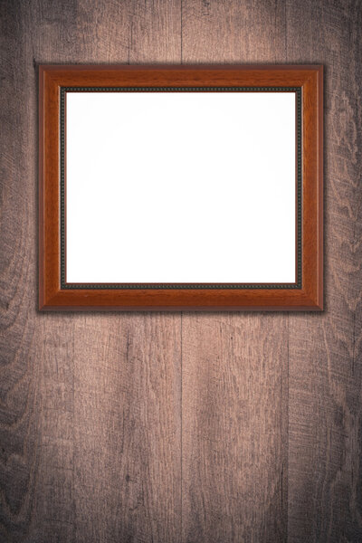 Brown picture frame on vintage wood wall.