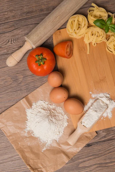 Raw pasta, tomato and eggs — Stock Photo, Image