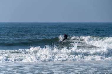 Okyanus dalgaları üzerinde eylem güneşli bir sörfçü.