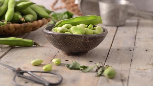 Fresh Raw Green Broad Beans Wooden Table — стоковое видео