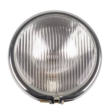 Close-up motorcycle headlight isolated in a white background.