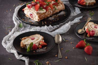 Meringue roll cake with cream, raspberries. Roulade, summer dessert served in ceramic plate.
