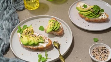 Healthy toast with avocado cream cheese and wheat bread on a plate. Delicious snacks and avocado sandwiches. Food composition, tasty Italian meal.