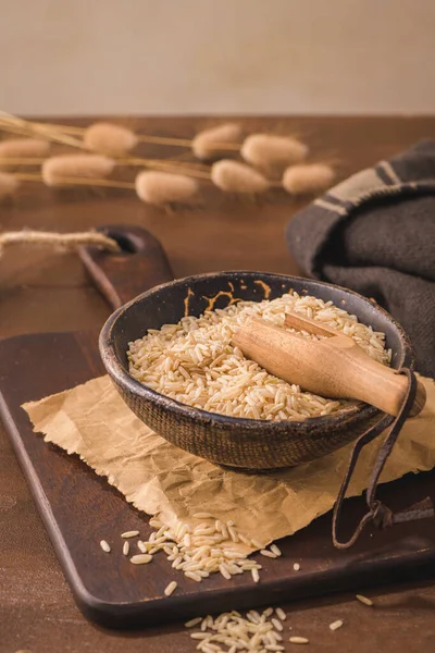 Brown Rice Ceramic Bowl Wooden Scoop Rustic Countertop — Fotografia de Stock