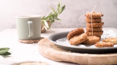 Breakfast concept with baked butter cookies, cappuccino coffee with creamy foam in ceramic cup.