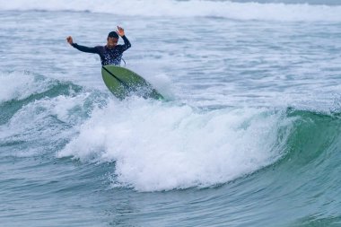 Brezilyalı sörfçü Portekiz 'in Atlantik kıyılarında hareket halinde. Furadouro plajında bulutlu bir sabah, Ovar - Portekiz.