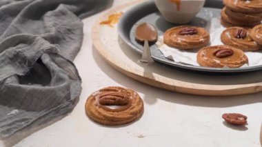 Cevizli karamelli kurabiyeler yuvarlak tabakta servis ediliyor, mutfakta pişirdikten sonra..